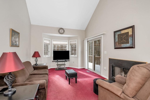 carpeted living room with high vaulted ceiling