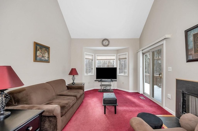 living room with carpet and high vaulted ceiling