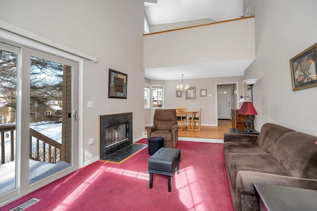 carpeted living room with an inviting chandelier and a high ceiling