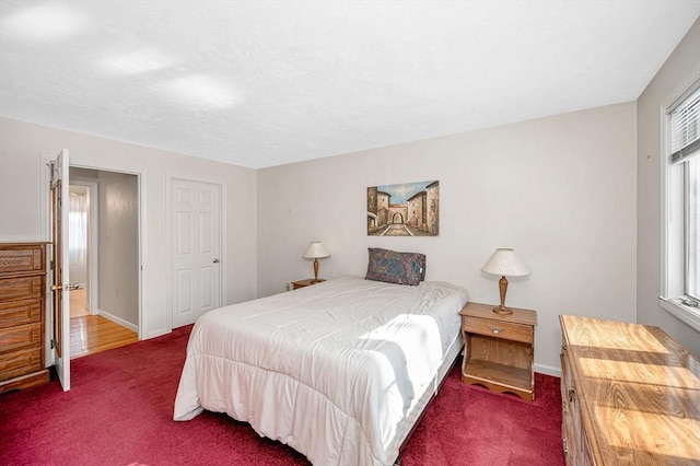 bedroom with dark colored carpet