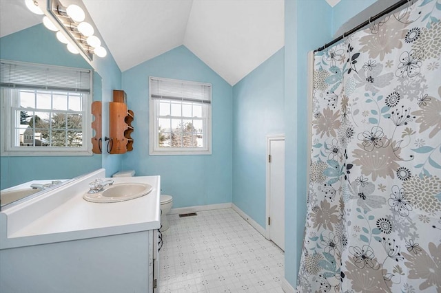 bathroom with toilet, vaulted ceiling, a shower with shower curtain, and vanity