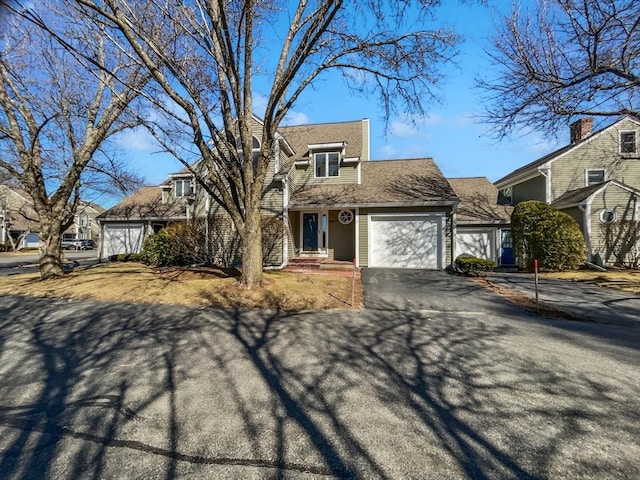 view of front facade featuring aphalt driveway and an attached garage