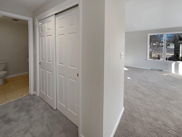 corridor with stairway, visible vents, baseboards, and carpet