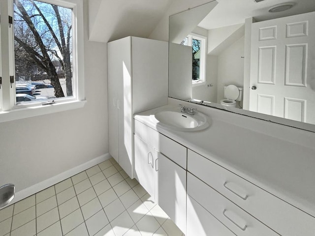 bathroom with tile patterned floors, toilet, vanity, and baseboards