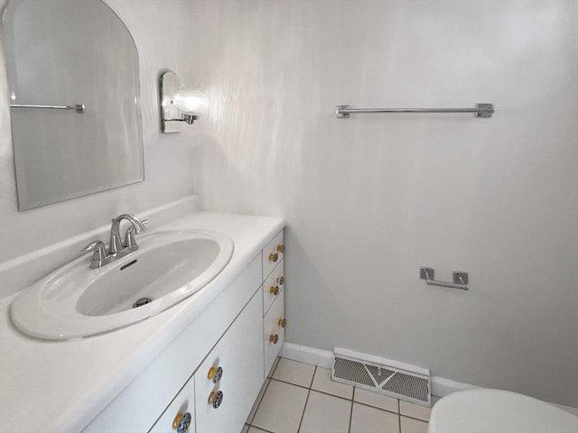 bathroom featuring visible vents, toilet, tile patterned flooring, baseboards, and vanity