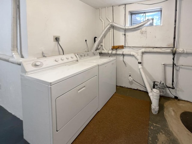 clothes washing area featuring washing machine and dryer and laundry area