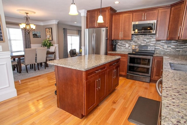 kitchen with light wood-type flooring, tasteful backsplash, and appliances with stainless steel finishes