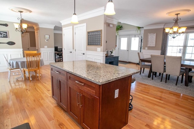 kitchen with a center island, decorative light fixtures, and an inviting chandelier