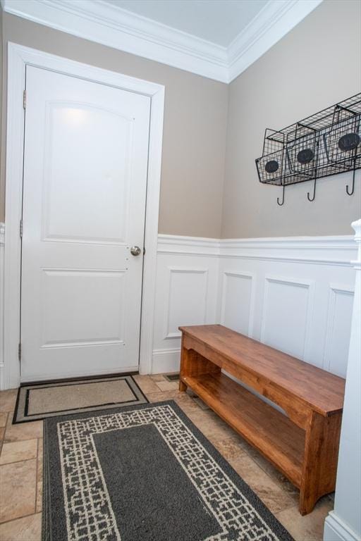 mudroom with a wainscoted wall and crown molding