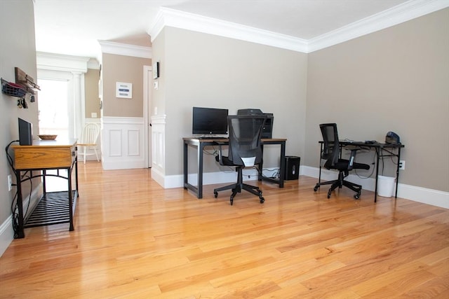 home office with light wood-style floors, ornamental molding, and baseboards