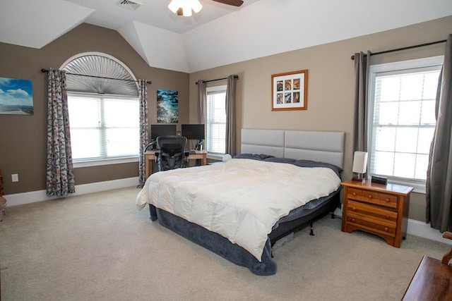 bedroom with ceiling fan, light carpet, visible vents, baseboards, and vaulted ceiling