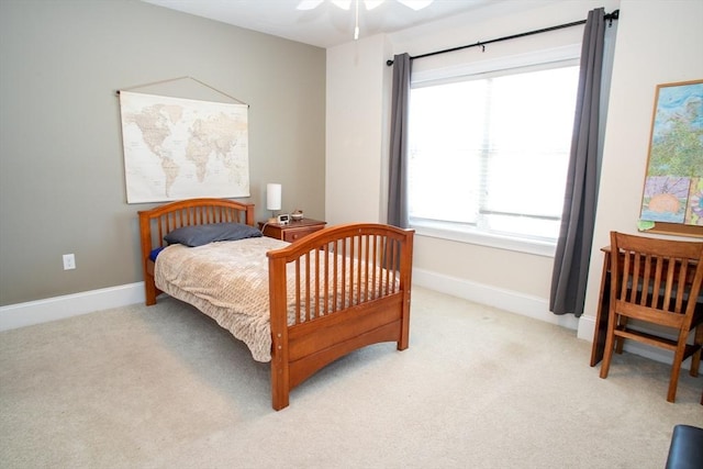 bedroom with light carpet and baseboards