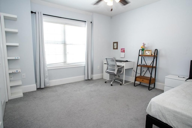 carpeted bedroom with ceiling fan and baseboards