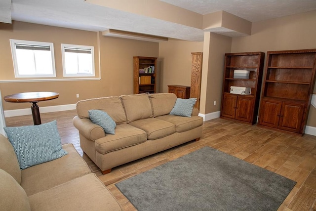 living area featuring light wood-style floors and baseboards