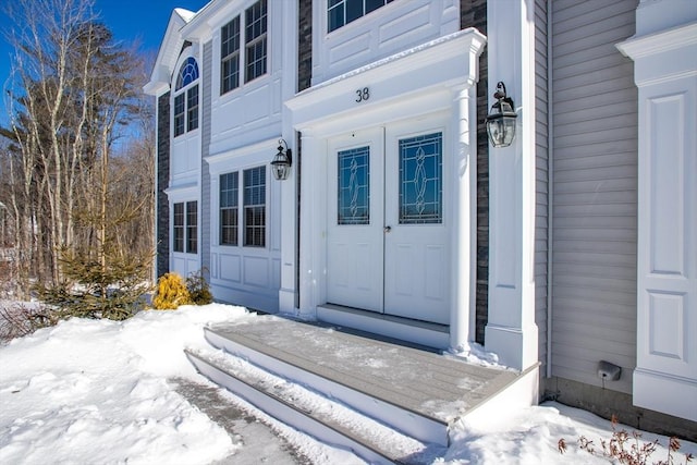 view of snow covered property entrance