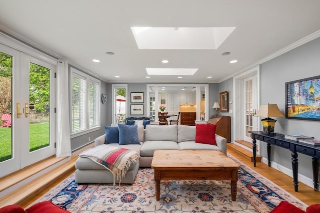 living room featuring crown molding, wood finished floors, recessed lighting, french doors, and a skylight