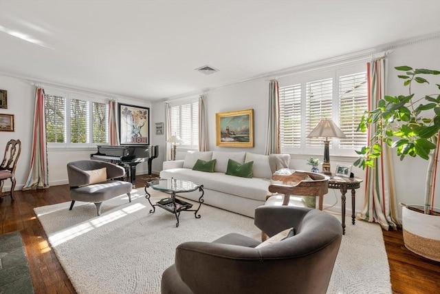 living area with dark wood-style floors and visible vents