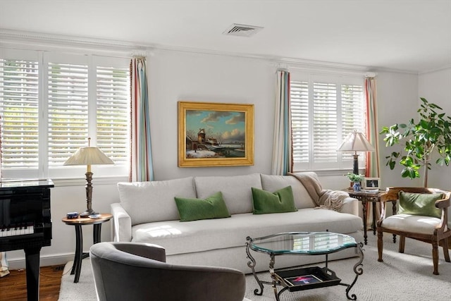 living room featuring crown molding and visible vents