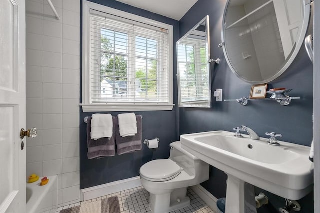 bathroom with baseboards, tile patterned flooring, and a wealth of natural light