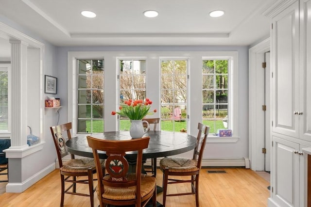 interior space with a baseboard heating unit, visible vents, and a healthy amount of sunlight