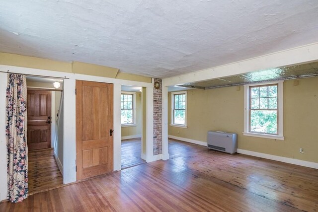 43 Meadow St, Northfield, MA 01360 - interior space featuring wood finished floors, heating unit, and a textured ceiling