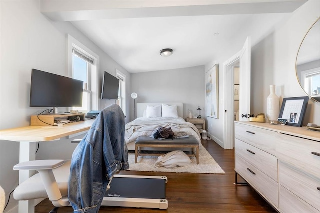 bedroom with multiple windows and dark wood-type flooring