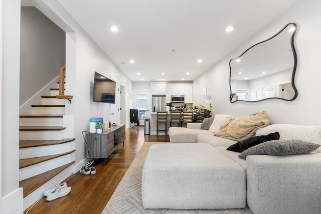 living area with stairs, dark wood-style floors, and recessed lighting