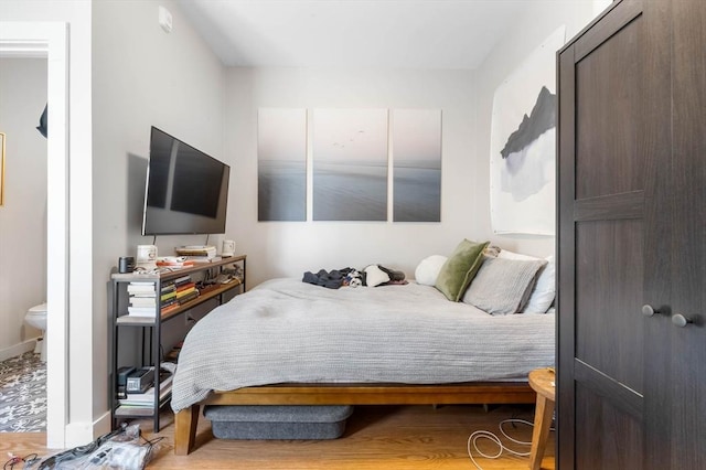 bedroom featuring wood finished floors and baseboards