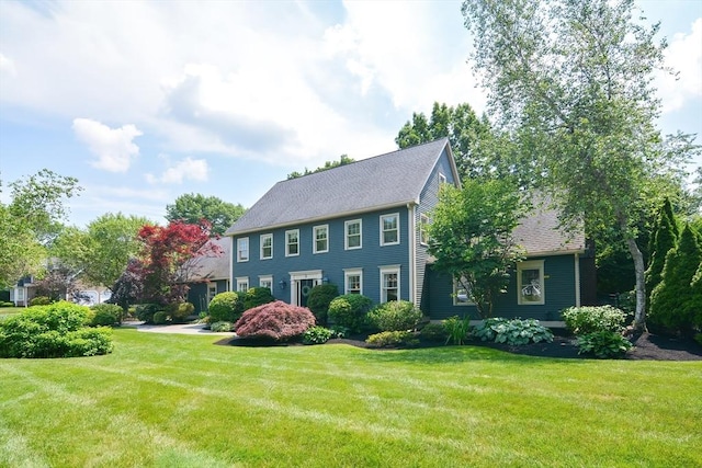 colonial home with a front lawn