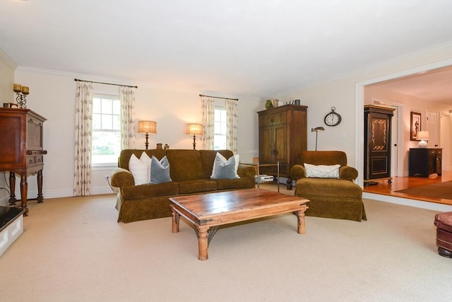 living room with baseboards, ornamental molding, and light colored carpet