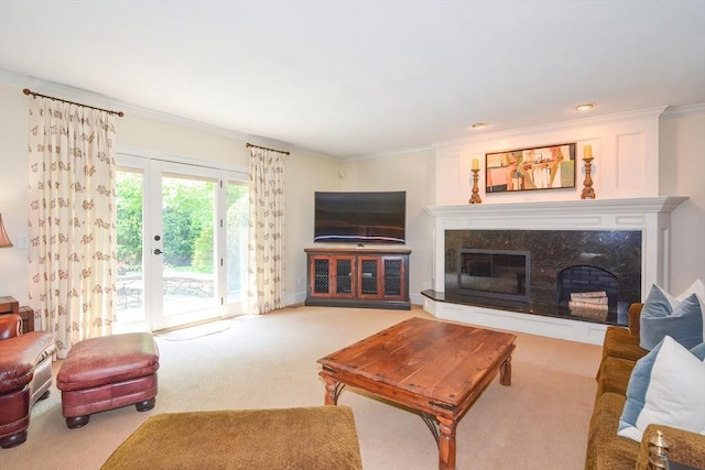 carpeted living room with crown molding and a fireplace