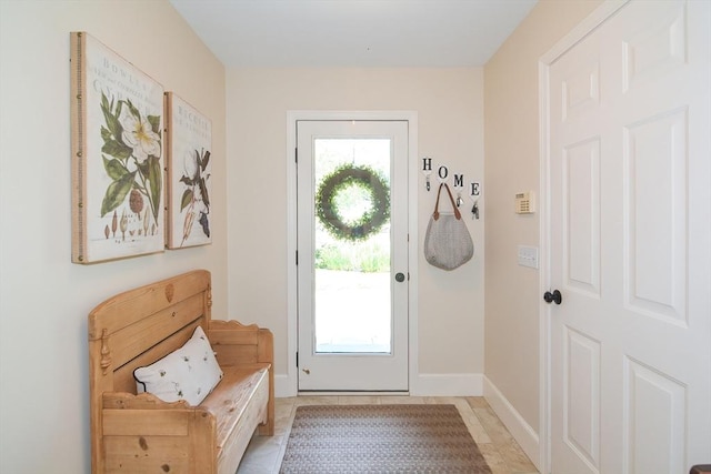 doorway with baseboards and a wealth of natural light