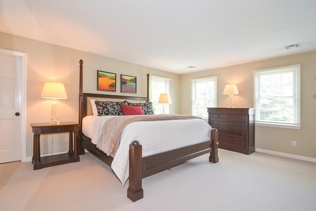 bedroom featuring light carpet, visible vents, and baseboards