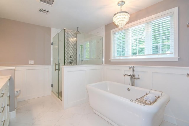 bathroom with marble finish floor, a wainscoted wall, a soaking tub, visible vents, and a stall shower