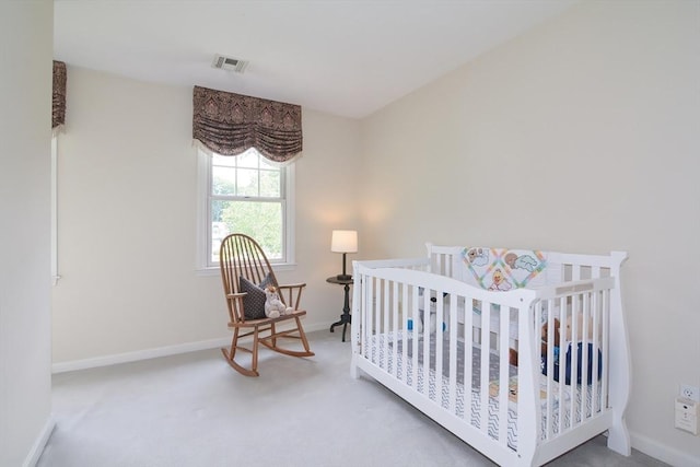 carpeted bedroom featuring visible vents and baseboards