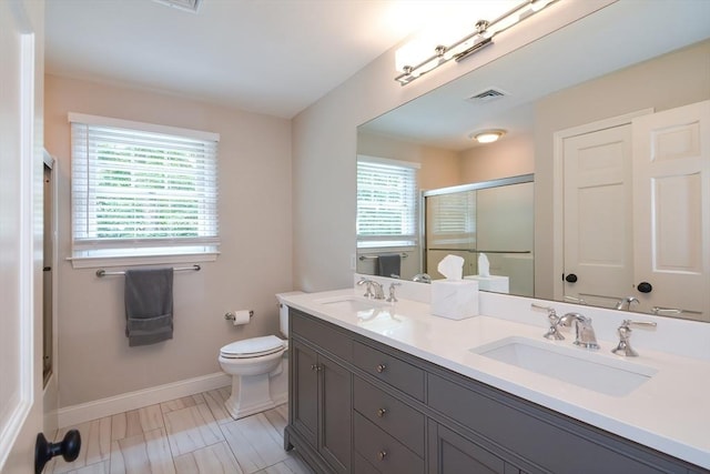 full bath with a stall shower, visible vents, a sink, and toilet