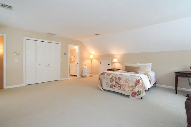 bedroom with carpet floors, visible vents, and vaulted ceiling