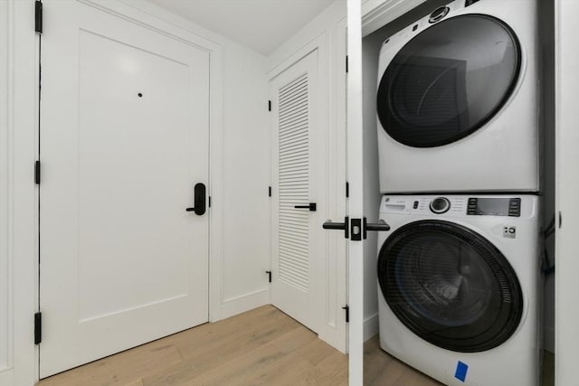 50 Leo M Birmingham Pkwy Unit 501, Boston, MA 02135 - laundry area featuring stacked washer / drying machine and light wood finished floors