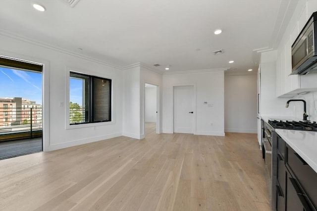 50 Leo M Birmingham Pkwy Unit 501, Boston, MA 02135 - kitchen featuring stainless steel appliances, light wood-style floors, light countertops, recessed lighting, and baseboards