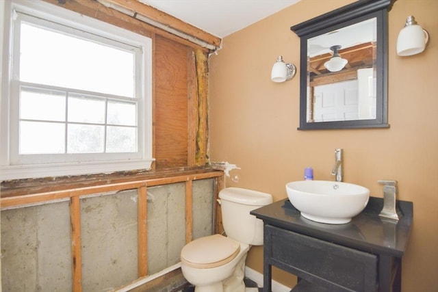 bathroom with vanity, a wealth of natural light, and toilet