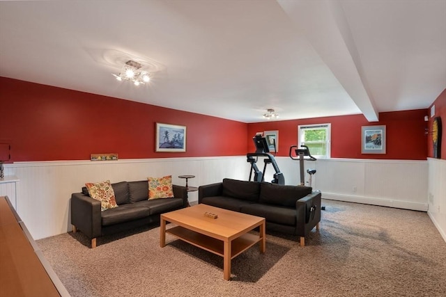 living room featuring carpet and beam ceiling