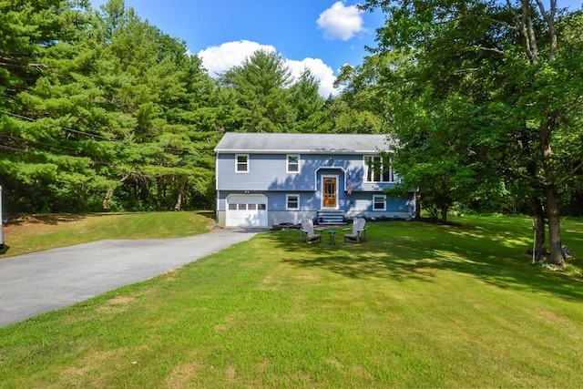 bi-level home featuring a garage and a front yard