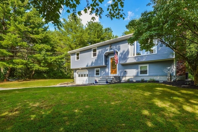 view of front of home featuring a garage and a front lawn