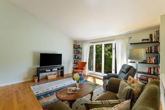 living room with lofted ceiling and hardwood / wood-style flooring