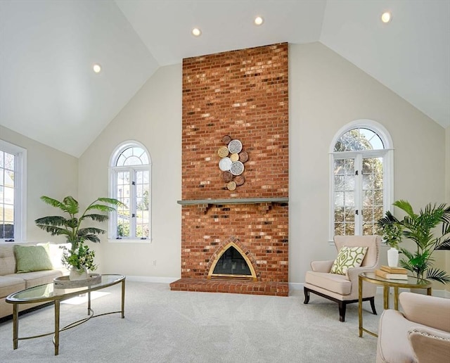 living room with light colored carpet, a healthy amount of sunlight, and a fireplace