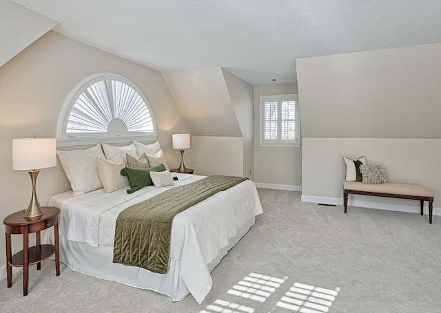 bedroom with vaulted ceiling and light carpet