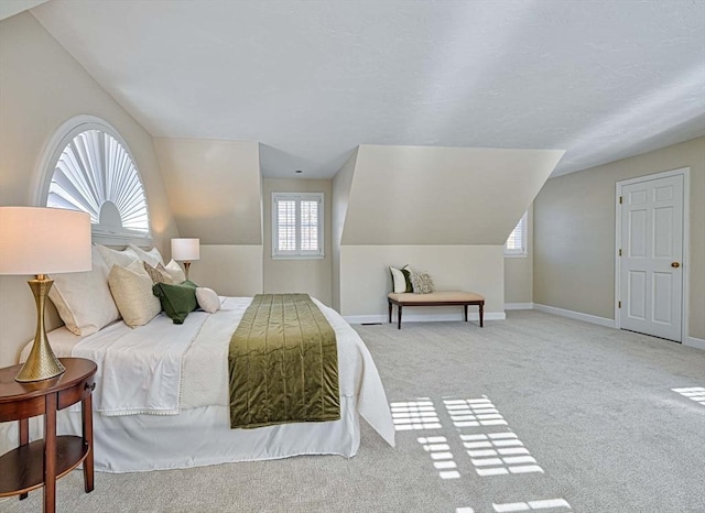 carpeted bedroom with vaulted ceiling