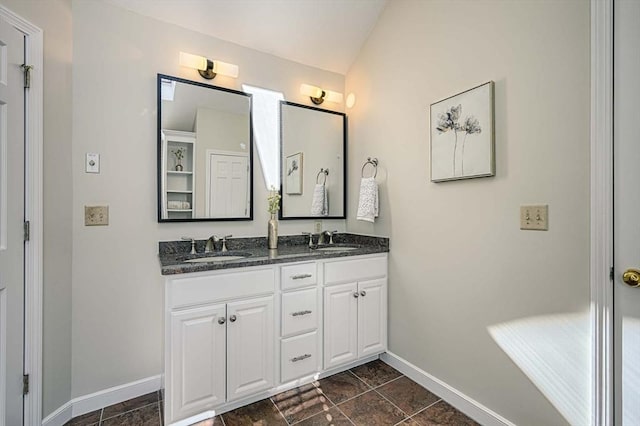 bathroom featuring lofted ceiling and vanity