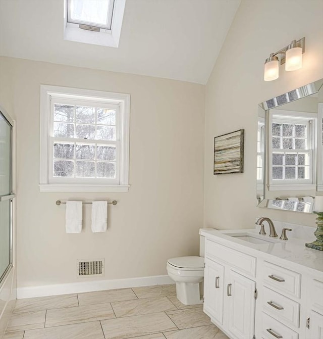 full bathroom featuring vanity, toilet, shower / bath combination with glass door, and vaulted ceiling with skylight