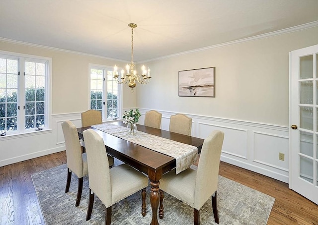 dining area featuring crown molding, dark hardwood / wood-style flooring, french doors, and a notable chandelier